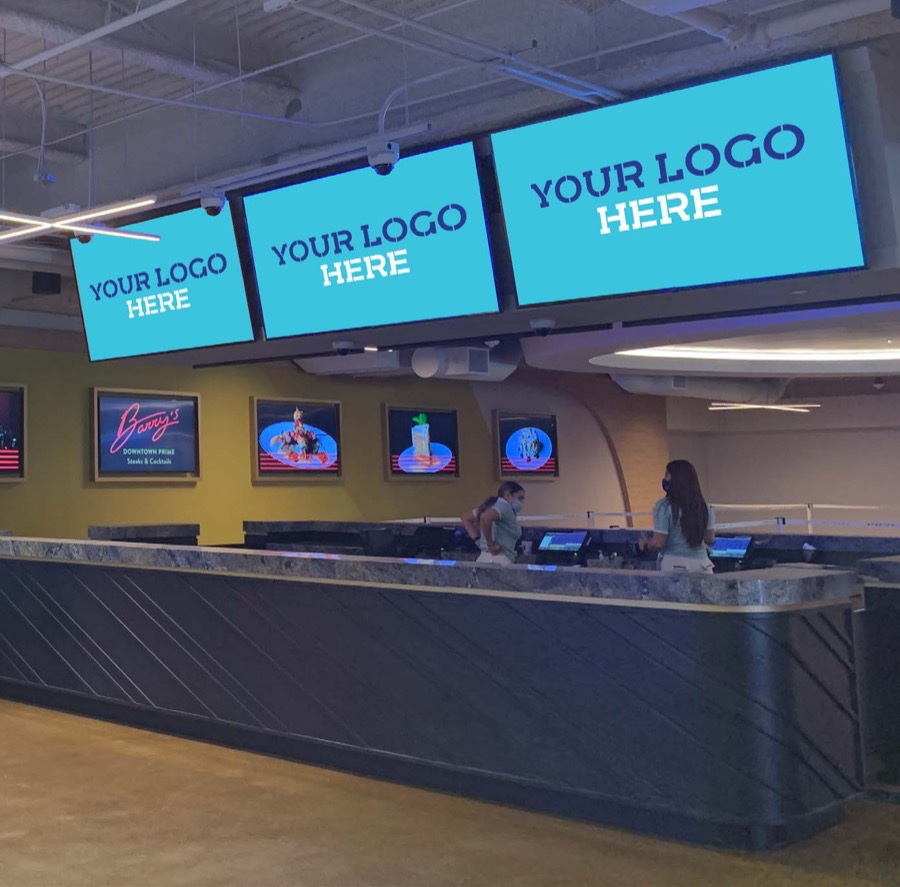 Check-in screens above the welcome desk